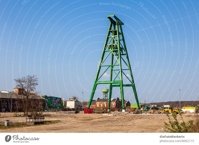 deconstructed green winding tower in front of a blue sky Architecture colors Mine tower Tower Water tower Gray Sky Exterior shot Industry The Ruhr Mining