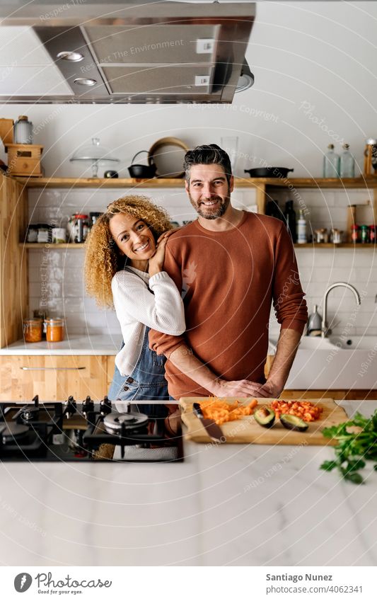 Couple hugging in the kitchen. middle age couple love cooking home cozy caucasian relationship preparing female happy person stove woman beautiful girl smiling