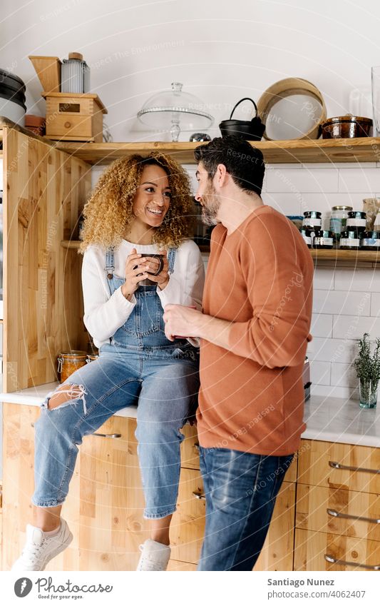 Couple laughing and standing in kitchen. middle age couple love cooking home cozy caucasian relationship preparing female happy person stove woman beautiful