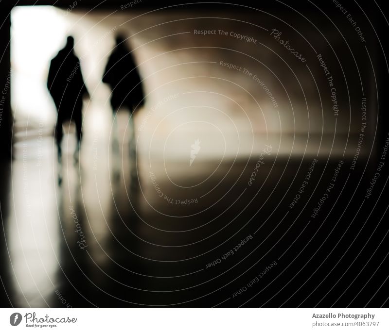 Human silhouettes in an underground passage. People in blur. abstract adult art background blurred blurry bokeh business concept couple defocused dynamics fast