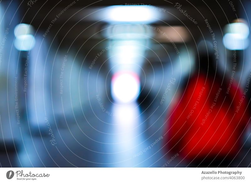 Silhouette of a young attractive lady in red in blur. abstract aim beam blue blurry bright color conceptual defocused direction end expression forward future