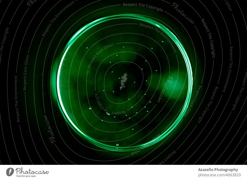 Abstract sphere in green with tiny bubble. Greec circle on a black background abstract art astral banner blur blurry bright button center central circular