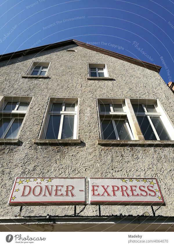 Old building with structure plaster in natural colors and the sign Döner Express in the summer at sunshine in the old town of the Hanseatic city Lemgo near Detmold in East Westphalia-Lippe in Germany