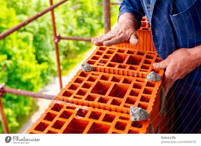 Worker is building wall with red blocks and mortar Accuracy Accurate Activity Architecture Block Brick Bricklayer Bricklaying Brickwork Builder Building Site
