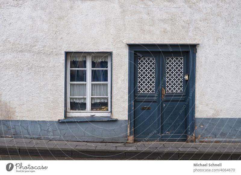 Entrance and window of an old house Building house facade Old Front door Window Blue Wooden door Exterior shot Deserted Closed