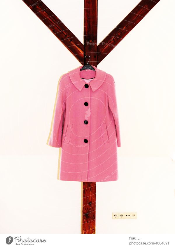 A pink coat hangs from the rafter Support beam Coat Interior shot Fashion Winter coat Socket Pink Wall (building) Flash photo Ladies' fashion