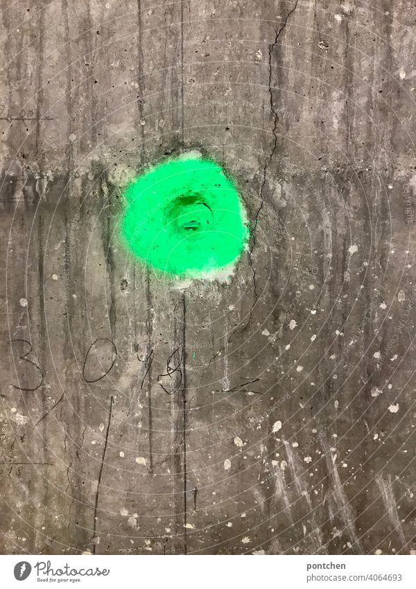 a green dot on a wall of concrete. marking neon Green Colour Concrete Wall (barrier) Construction site construction works Point