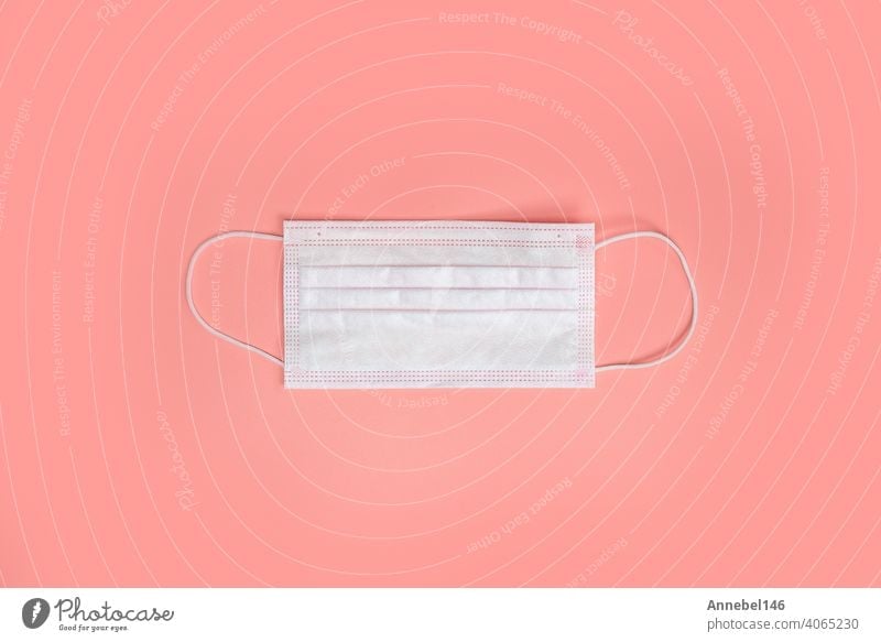 Medical disposable protective face masks on a pink background. The concept of protecting health from the virus. Copy space, top view. flat lay Coronavirus, covid-19,business, health concept