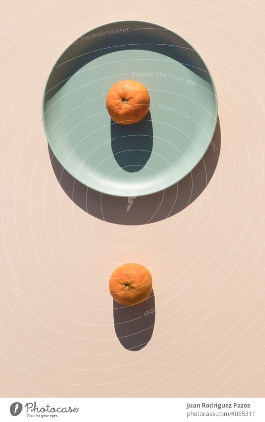 Minimalist image of two mandarins minimal geometric shape hard shadows healthy fruit rounded orange color minimalist shade vitamin simplicity tangerine citrus