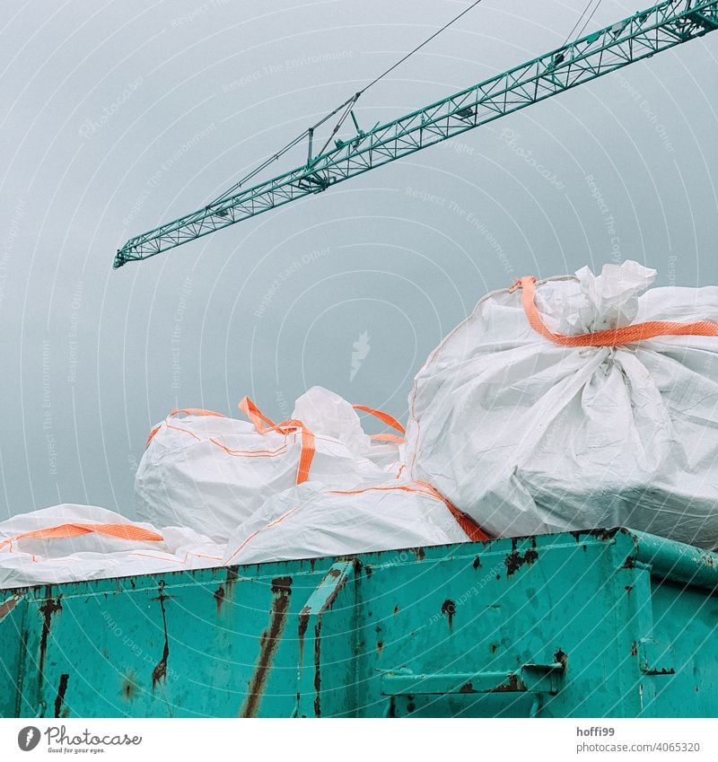 Construction waste in bags on a container Building rubble Special waste Construction site Plastic Garbage bag Container Dispose of Waste management