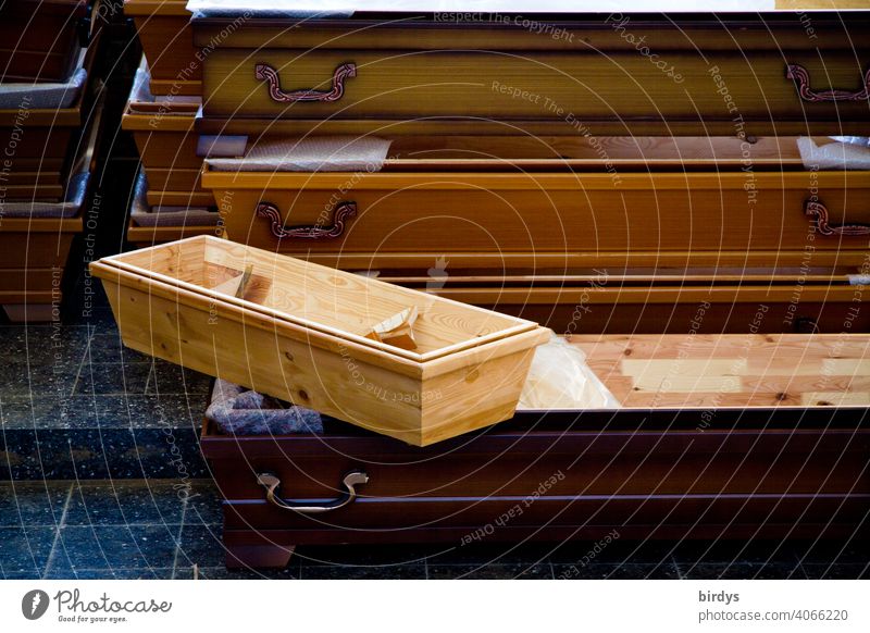 Child's coffin and other coffins on top of each other. Mortality ,Death and mourning pass away Grief Coffin Coffins Child's Coffin sorrowful Transience Goodbye