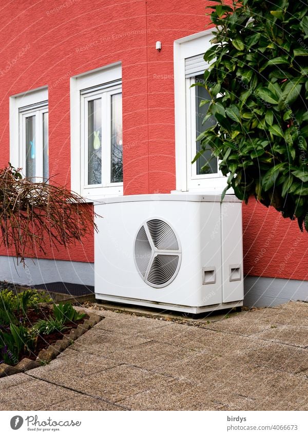 Air source heat pump in front of a terraced house. Modern, environmentally friendly heating technology, air source heat pump Heating Air-to-water heat pump