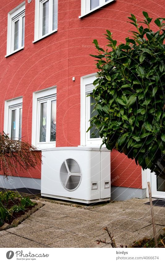 Air source heat pump in front of a terraced house. Modern, environmentally friendly heating technology, air source heat pump Heating Air-to-water heat pump
