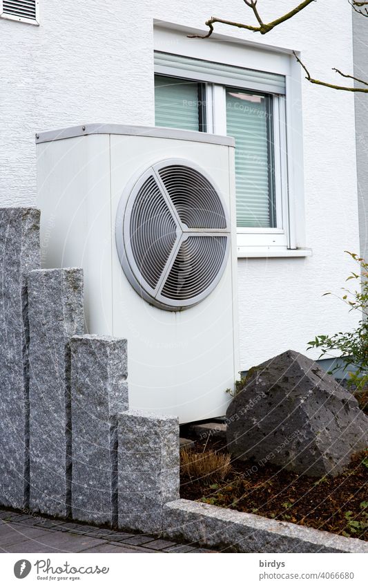 Air source heat pump in the front garden of a house. Modern, environmentally friendly heating technology. Air source heat pump Heating Air-to-water heat pump