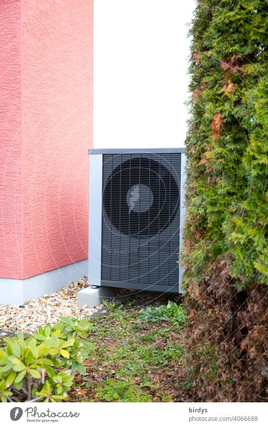 Air source heat pump in the front yard of a home. Air source heat pump house corner Air-to-water heat pump Front garden Environmental protection