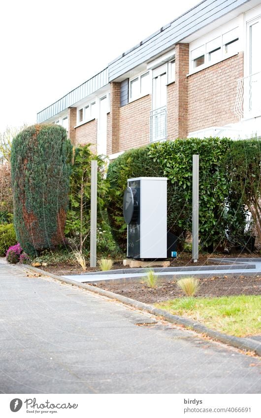 Air source heat pump in the front garden of a terraced house. Modern, environmentally friendly heating technology Heating Air-to-water heat pump sustainability