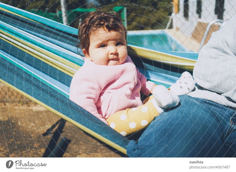 Little baby having fun on a hammock in a sunny day happy holidays lifestyle family babyhood child kid girl cute lovely time enjoy happiness leisure freedom