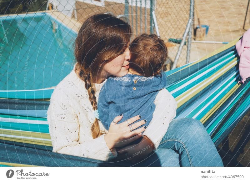 Image about real motherhood of a young mom hugging her baby life love family cute infancy child kid girl youn woman caring lovely home outdoors holidays vacancy
