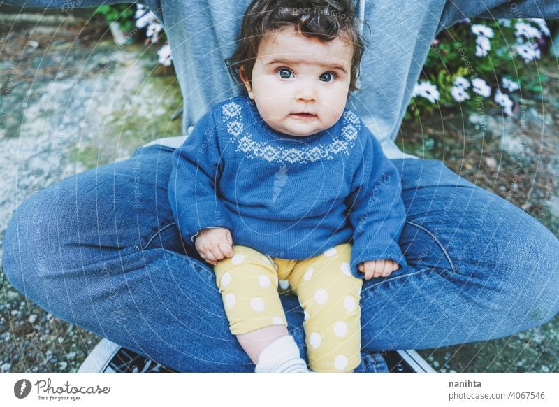 Little baby portrait sitting on his dad legs single parent real family jeans casual candid little girl male man youth parenthood childhood babyhood family time
