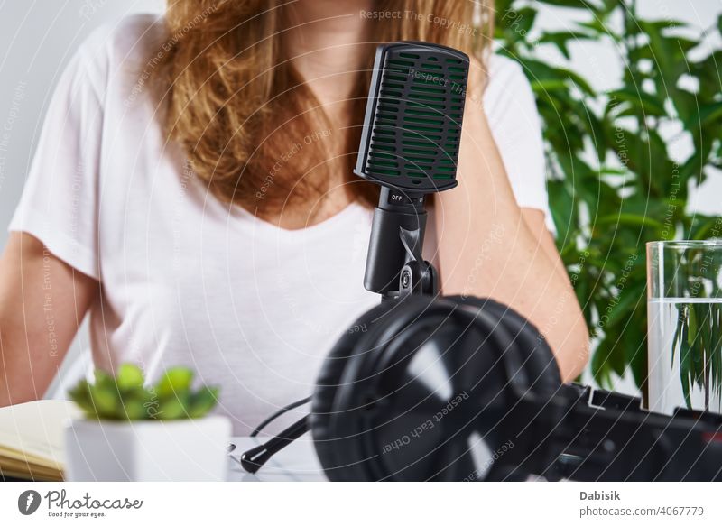 Podcast concept. Woman recording online course microphone headphones workplace podcast audio radio technology top view keyboard remote education learning