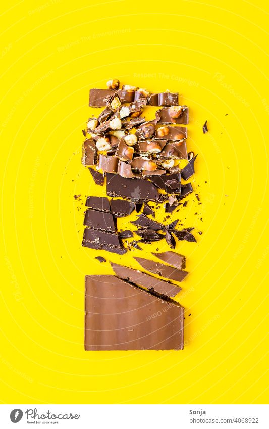 Variation of chocolate pieces on a yellow background Chocolate slice variation Nut Candy Studio shot Style Nutrition Colour photo Sugar Brown Food photograph