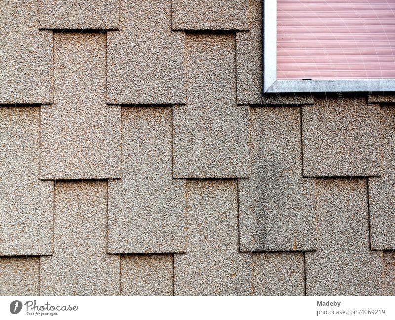 Facade design with rectangular shingles and framed roller shutters in the natural-coloured facade of a residential house in Wettenberg Krofdorf-Gleiberg near Gießen in Hesse