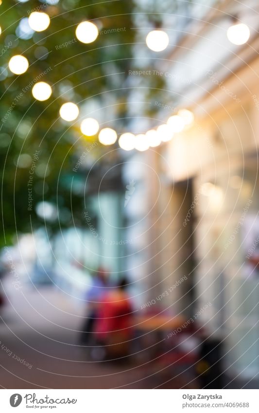 Blurred view of street cafe lights. - a Royalty Free Stock Photo from  Photocase