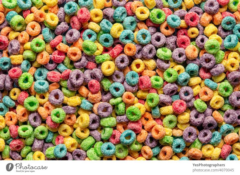 Colorful cereals background. Fruit flavored ring cereals full-frame above view assorted backdrop blue breakfast childhood close-up colorful colors confectionery