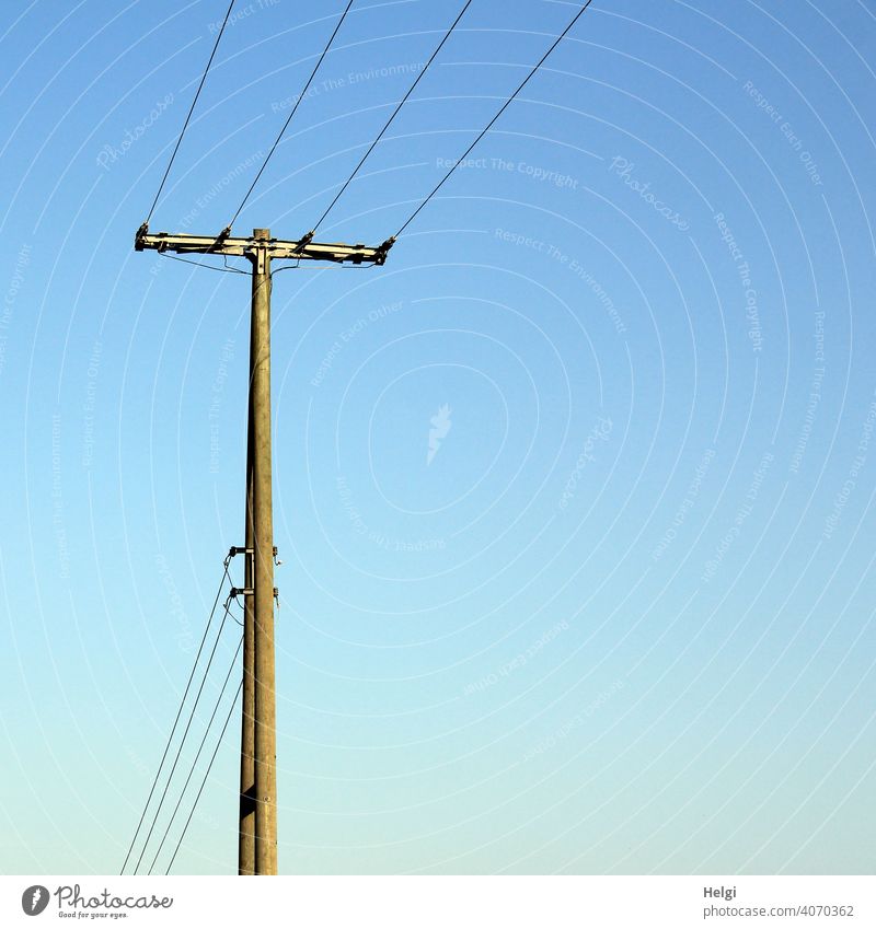 Wooden power pole with power lines Electricity pylon Old Cable Transmission lines Energy industry Power transmission Exterior shot co2 Sky Blue sky Technology