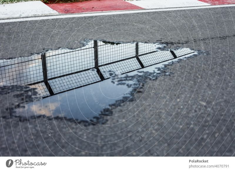 #A0# Curve with pitfalls curvaceous racetrack Running Asphalt Speed Puddle reflection Street Driving Exterior shot Colour photo Transport Motoring Road traffic
