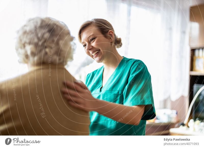 Healthcare worker at home visit real people candid genuine woman senior mature female Caucasian elderly house old aging domestic life grandmother pensioner