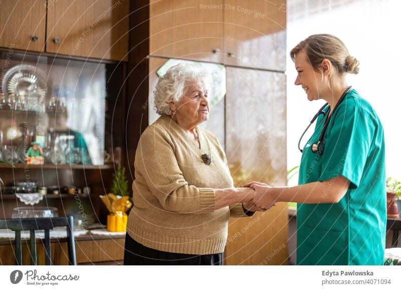 Healthcare worker at home visit real people candid genuine woman senior mature female Caucasian elderly house old aging domestic life grandmother pensioner