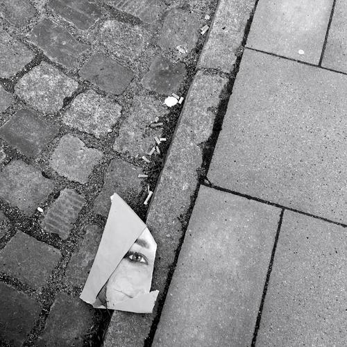careless Image portrait Poster EXCERPT section Street paving stone Cigarette Butt Woman Face Eyes Looking Paper off