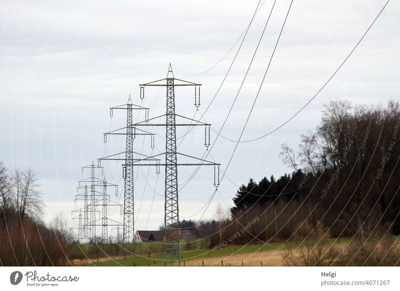 several power pylons with high voltage lines in front of cloudy sky Electricity pylon Power lines Energy High voltage power line Energy industry Technology