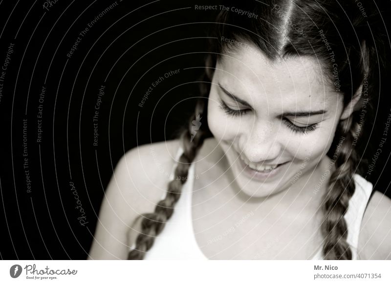 young woman with braided pigtails looks down portrait Head Woman Face Shoulder Feminine Esthetic Longing naturally Emotions Cool (slang) pretty good-looking