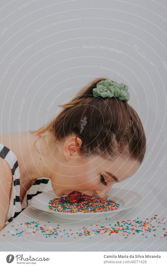Woman with head on plate with sweet colorful confetti anniversary anxiety background beautiful birthday candy celebration copyspace creative decoration easter