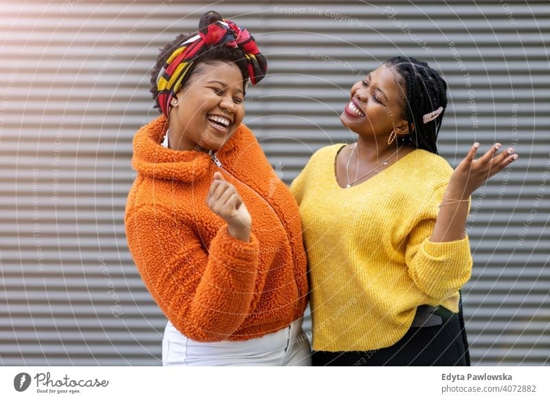 Two beautiful Afro american women having fun together in the city diversity diverse people love outdoors day positivity confident carefree woman young adult