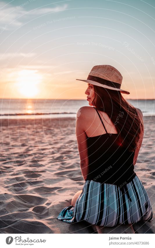 young woman with hat on beach on vacation nature summer ocean sea sky sunny happiness natural wireless leisure activity portrait travel girl communication