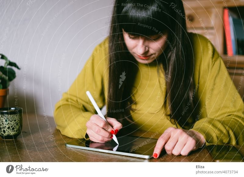 A woman sits at the table and draws or writes something on a tablet Painting (action, artwork) Write Draw pen Ipad Apple Pen Creativity Digital Graphic Designer
