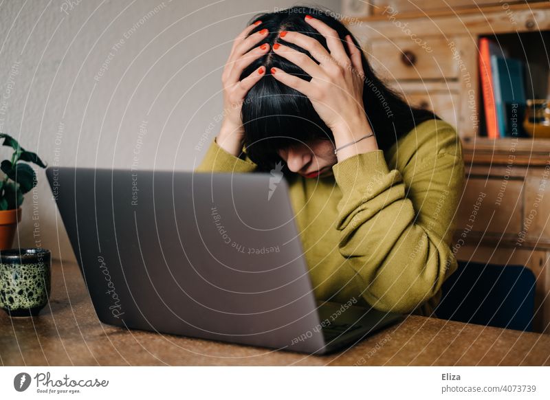 Woman desperate in front of laptop at home in home office Notebook stressed deadline frustrated overwhelmed Exasperated labour online study Student Digital