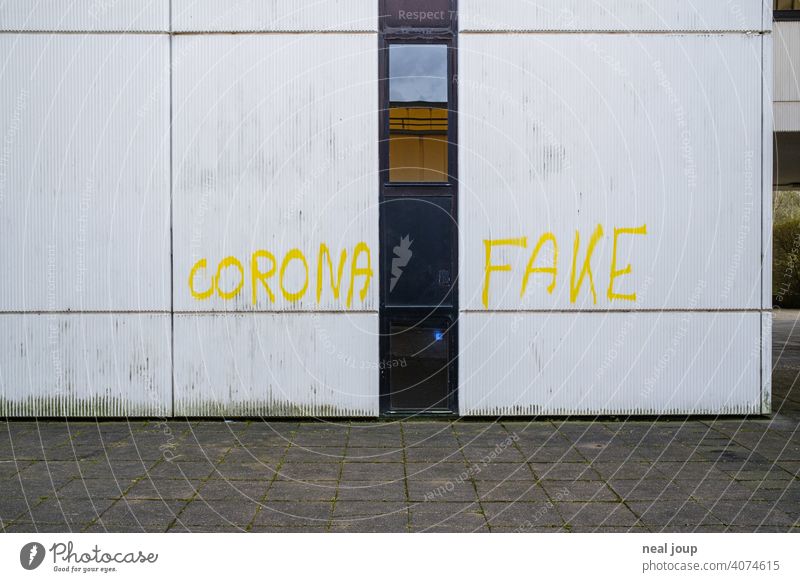 Yellow graffiti - Corona theme - on a white wall Crisis corona COVID Anger Opinion Comment pandemic Graffiti saying writing Handwriting Virus Healthy