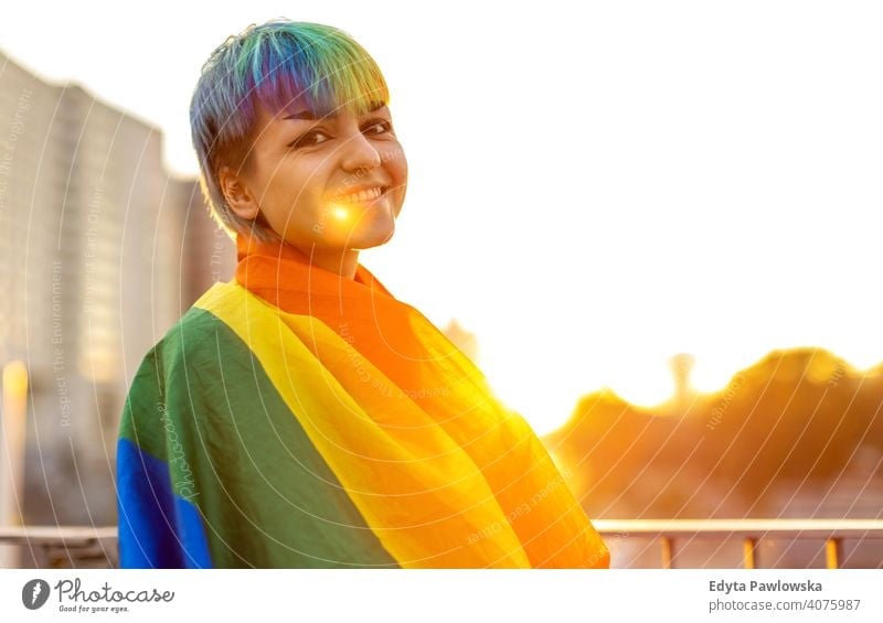 Portrait of a gender fluid person wearing rainbow flag non-binary gender fluidity lgbt equality homosexual lesbian pride gay parade man make-up identity