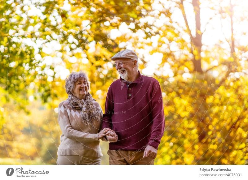 Happy senior couple enjoying a day outdoors in autumn love real people retired pensioner retirement aged grandmother grandparent grandfather two togetherness