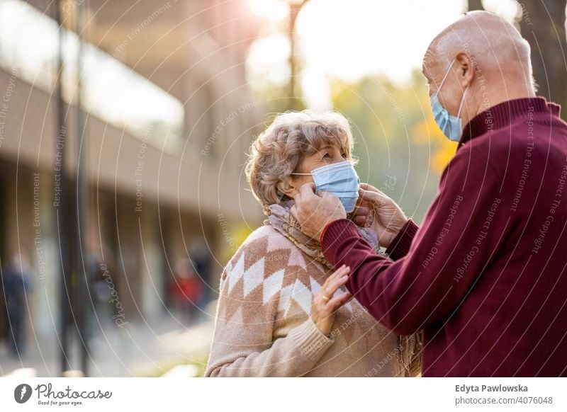 Senior couple wearing protective face masks outdoors senior love real people retired pensioner retirement aged grandmother grandparent grandfather day two