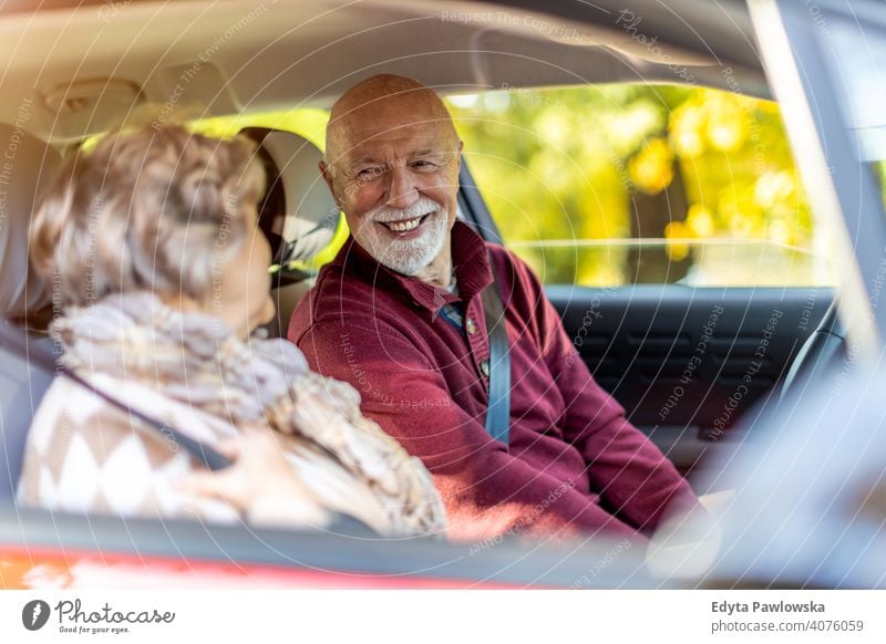 Happy Senior Couple travelling in their car vehicle driver driving journey trip road transport auto senior couple love real people retired pensioner retirement