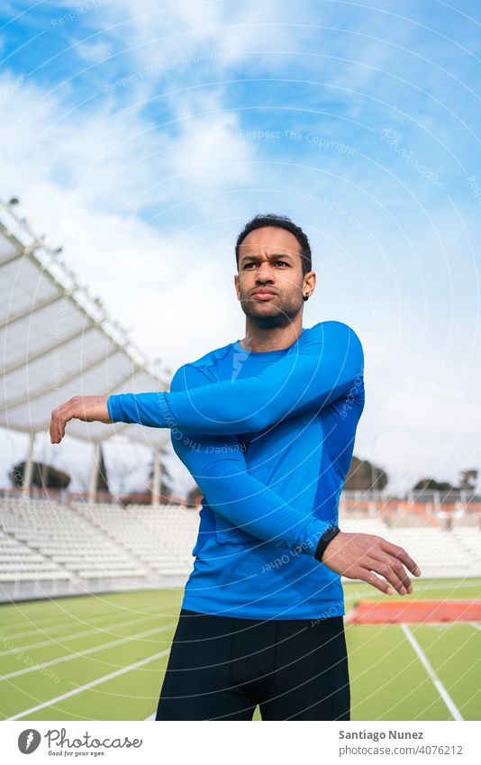 Black Athlete Stretching in Sports Track stretch stretching black man african american standing athlete runner arms sports track focus trainers male