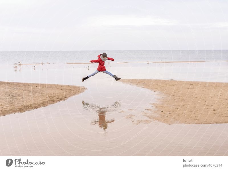 young girl jumping at the booth Girl Jump joyful leap Child Beach Skip Baltic Sea free time vacation holidays Autumn fortunate Joie de vivre (Vitality) cheerful