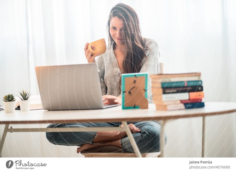 young woman teleworking at home with computer drinking coffee spectacles service one person call communication female businesswoman beautiful european people