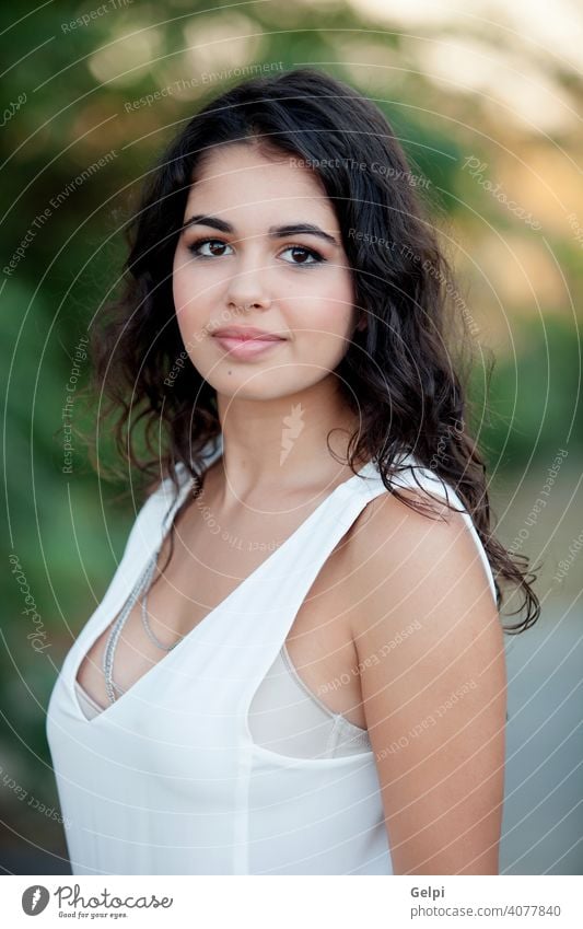 Beautiful brunette girl relaxing in the park portrait outside teenager pretty female young happy beauty cute nature woman green person attractive smile