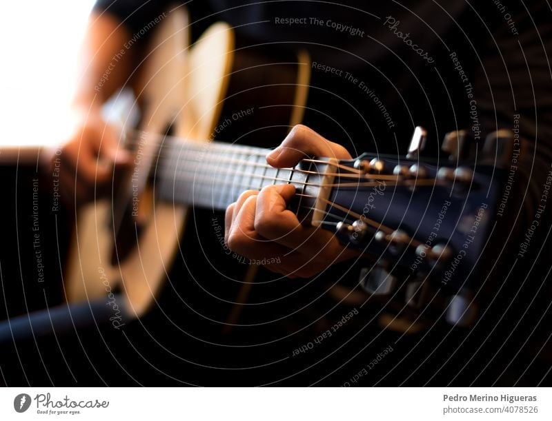 man playing acoustic guitar. Close-up music musician musical guitarist male sound instrument rock song player person performer performance young hand blues